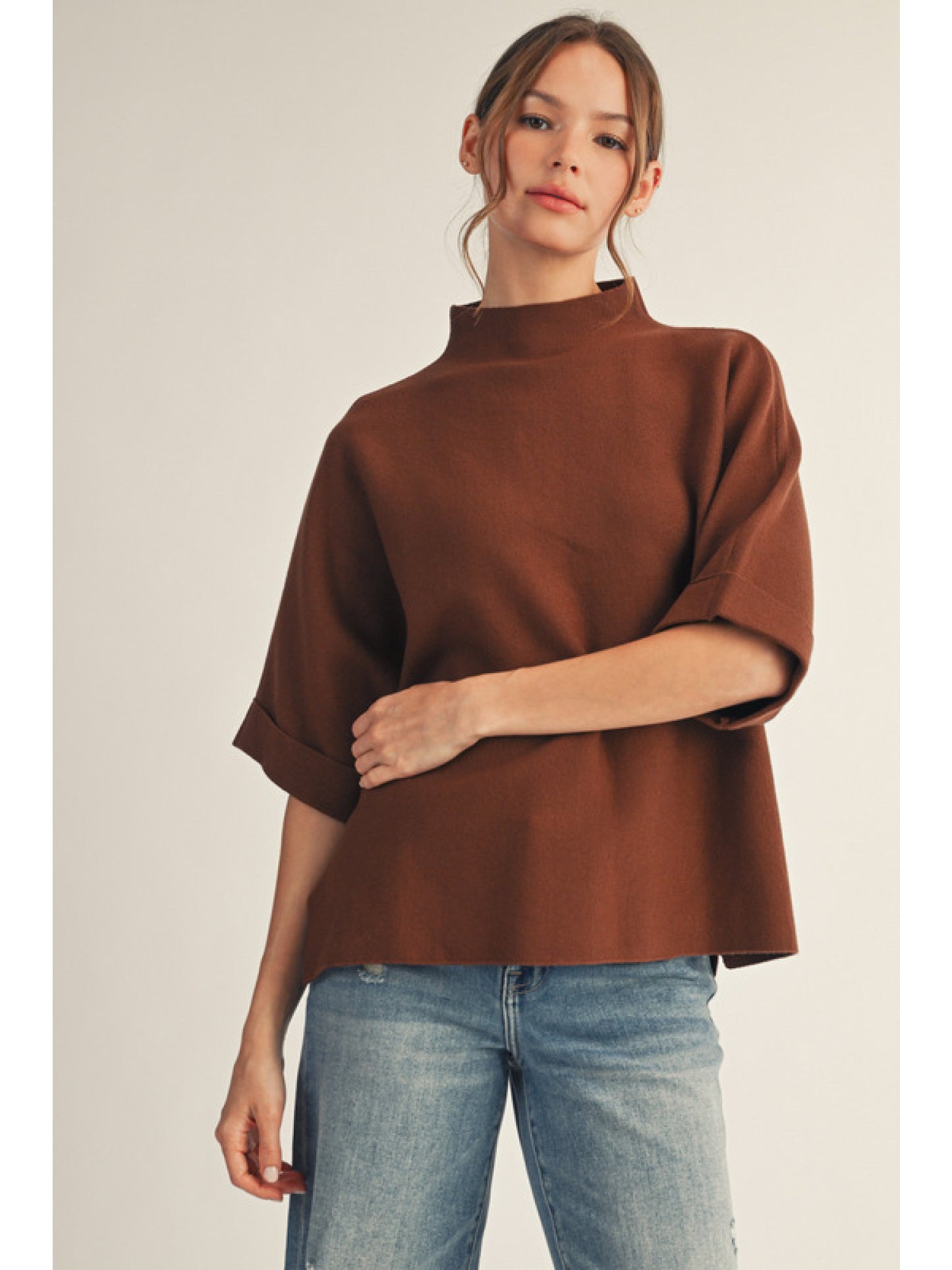 Brown Drop shoulder mock neck soft sweater top with side slit detail.