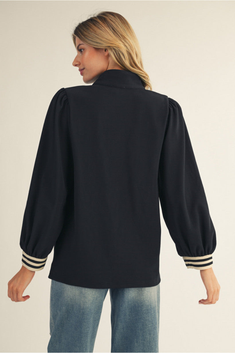 Long sleeves solid ribbed fabric high neck top with color rib band accent, front zip up, side slit.