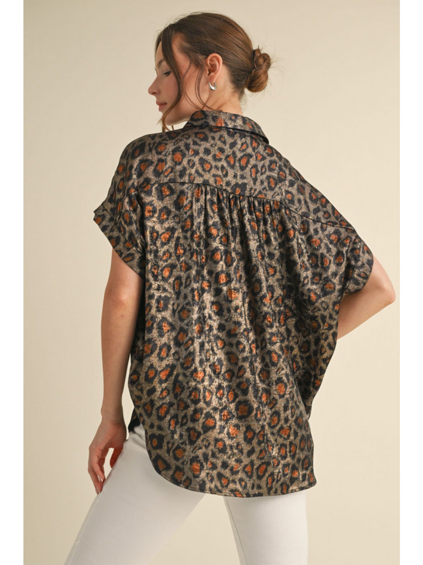 Black Leopard print collared button up top with cuffed short sleeves and ruched shoulders.