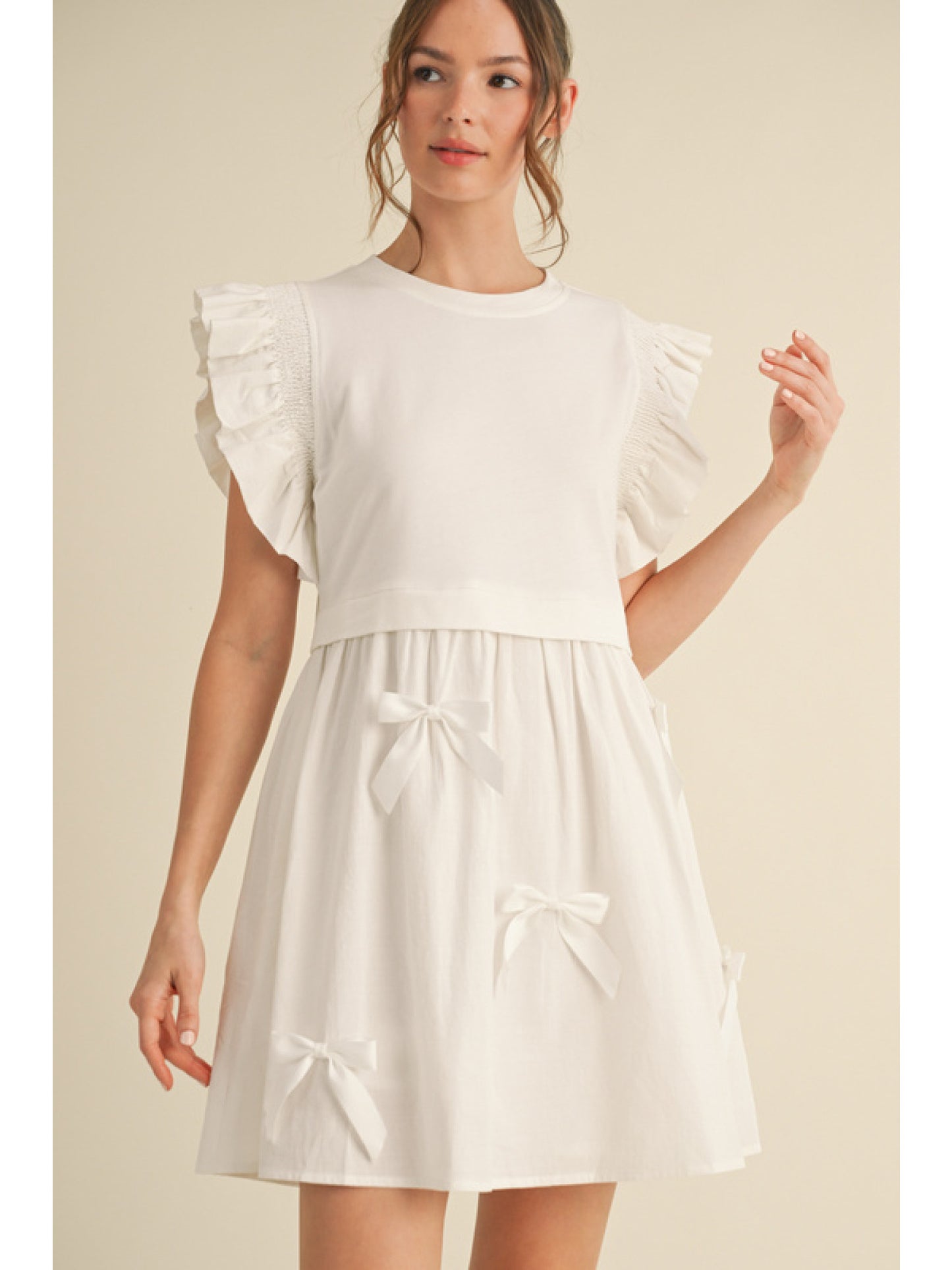 White Solid Twofer dress with U-neck, back key hole, ruffly trimming shoulder, side pockets featuring bow ties patch skirt.