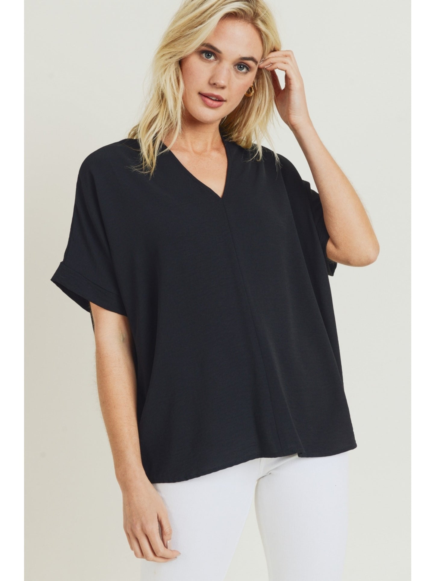 Black solid boxy top with a V-neckline and short sleeves.