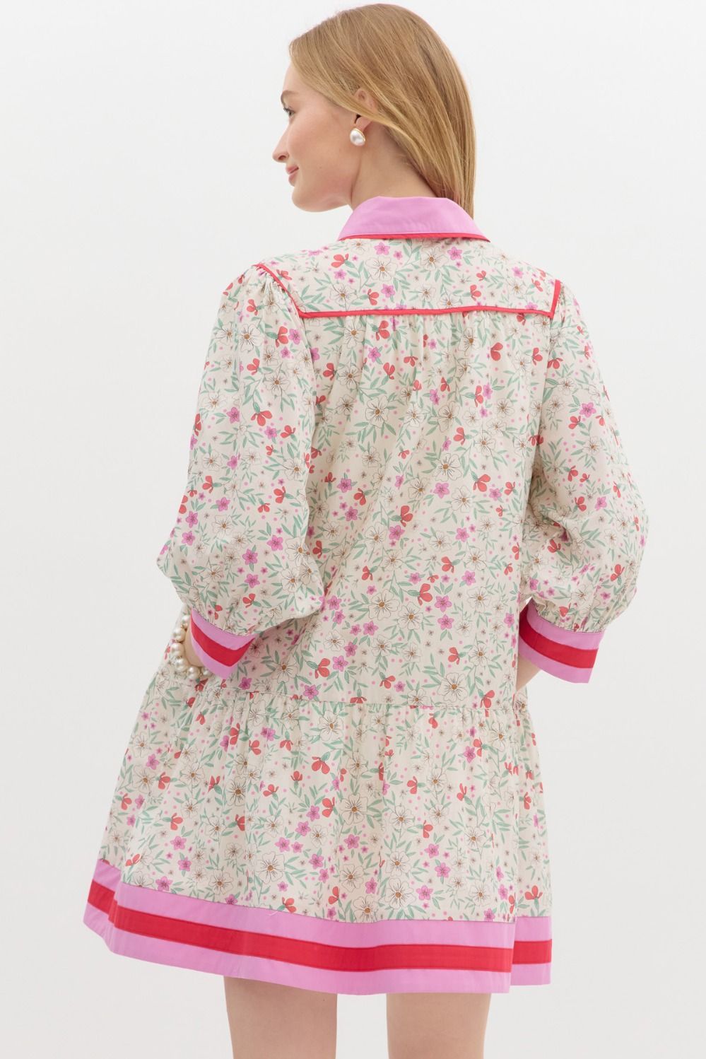 Ditsy floral print ¾ bubble sleeve ruffle hem mini dress featuring accented multicolor band finish at hem and cuff. Shirt collar button front closure.