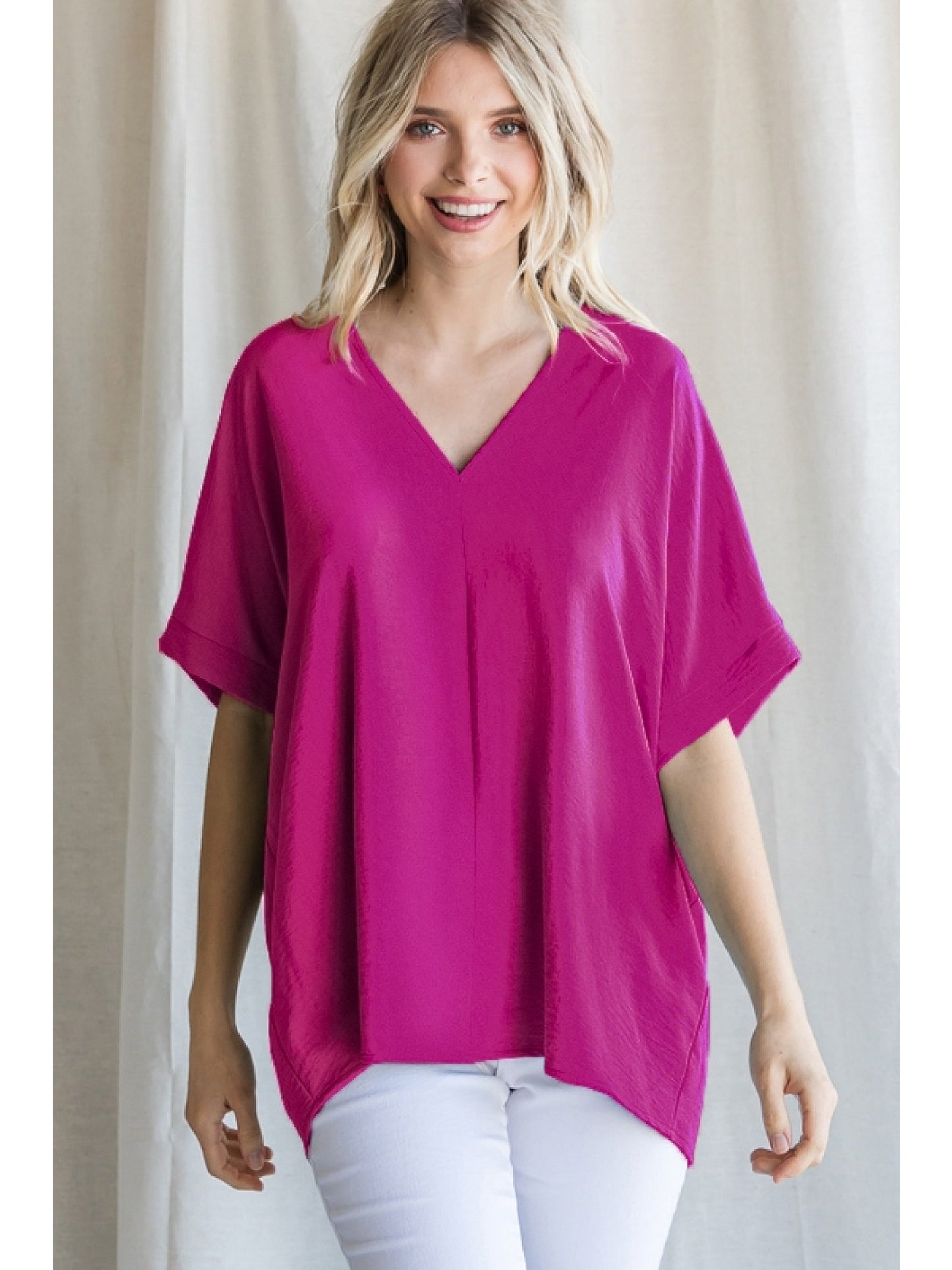 Magenta solid boxy top with a V-neckline and short sleeves.