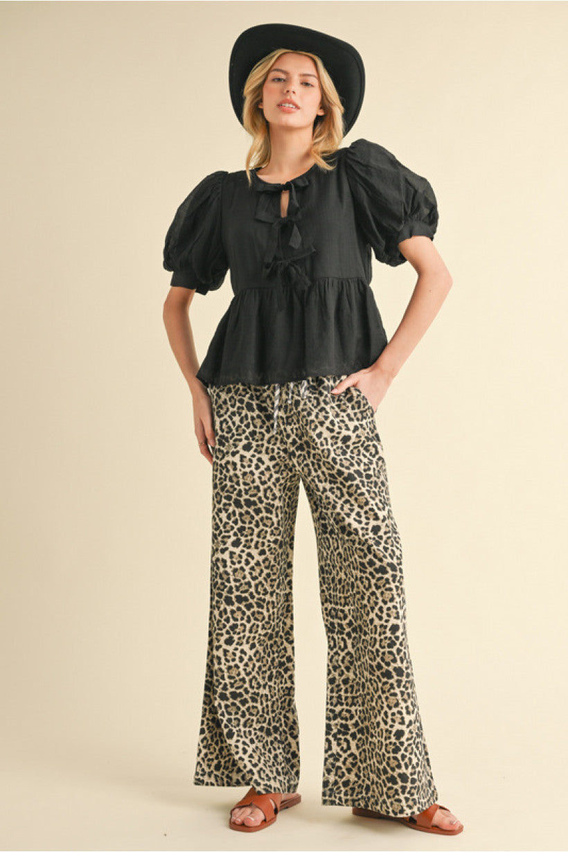 Leopard print pants with drawstring waistline features striped print,