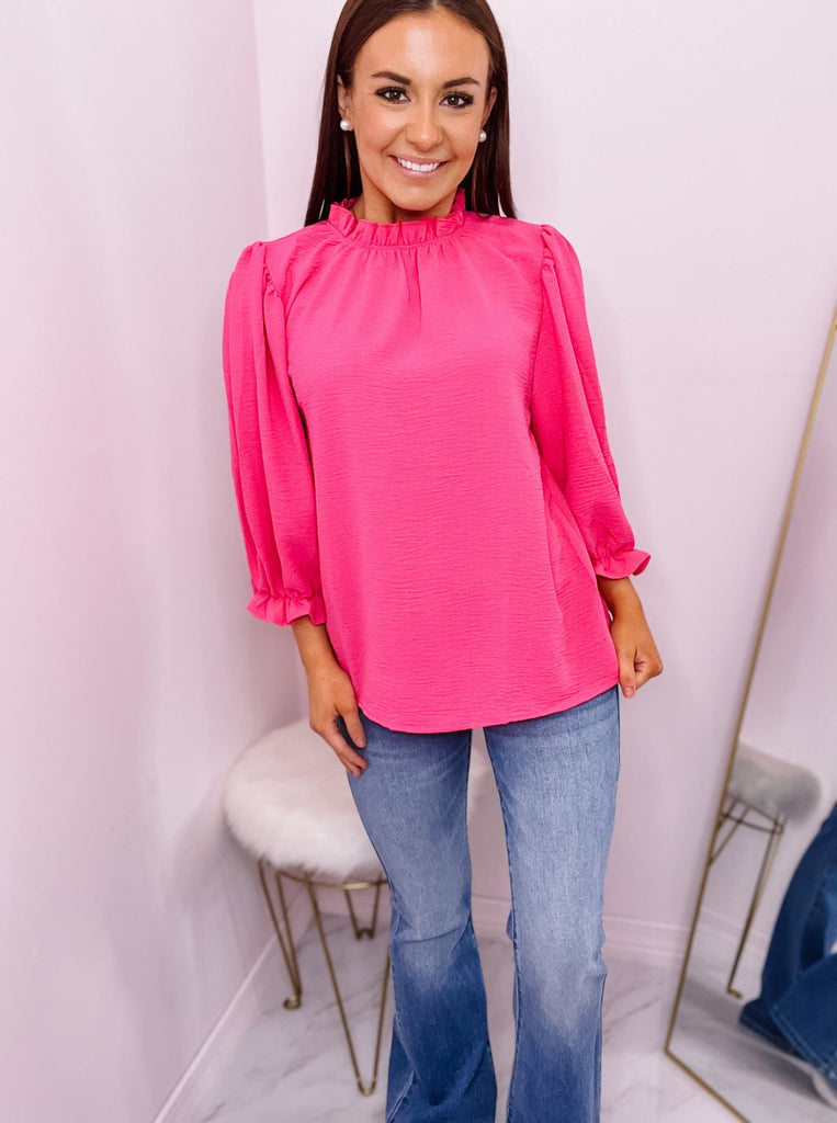 Hot Pink Solid half sleeve mock neck top featuring ruffled detail at neckline and cuffs.