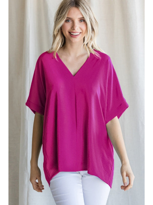 Magenta solid boxy top with a V-neckline and short sleeves.